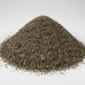 A close-up pile of loose-leaf tea leaves, showing a mix of dark brown, black, and light tan pieces, photographed against a white background.